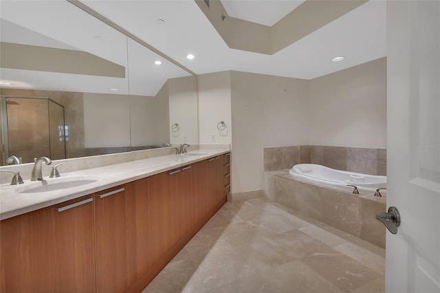 full bathroom featuring a sink, a stall shower, a bath, and double vanity