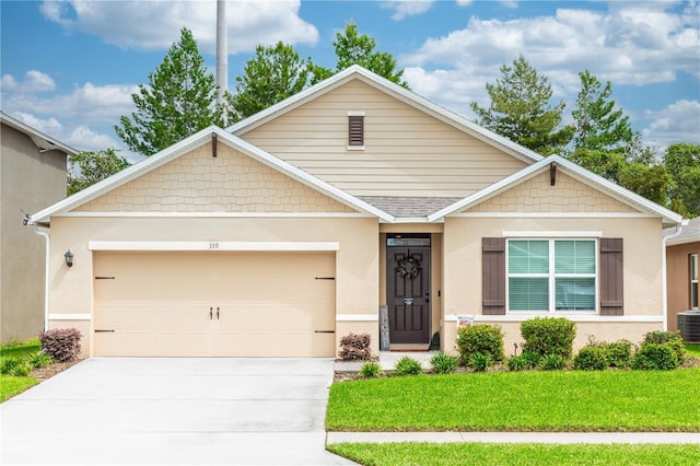 view of front of home with a front lawn, concrete driveway, roof with shingles, stucco siding, and a garage