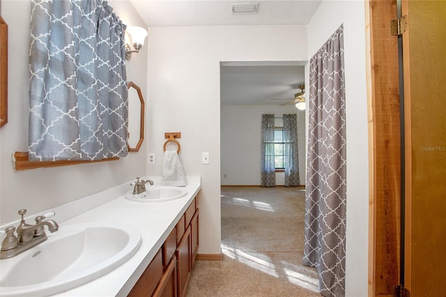 bathroom featuring a sink, visible vents, ceiling fan, and double vanity