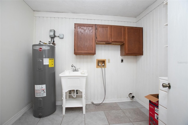 clothes washing area featuring water heater, cabinet space, baseboards, hookup for an electric dryer, and hookup for a washing machine