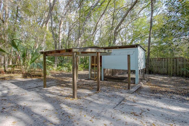 view of patio / terrace with an outbuilding and fence