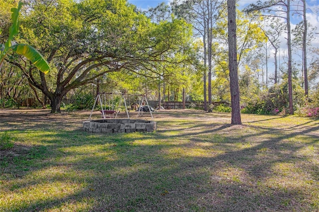 view of yard featuring a playground and fence