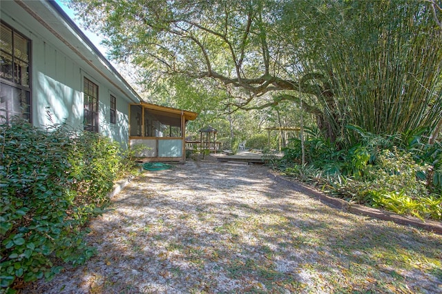 view of yard featuring a sunroom