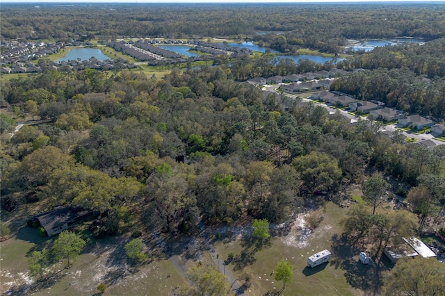 birds eye view of property with a forest view and a water view