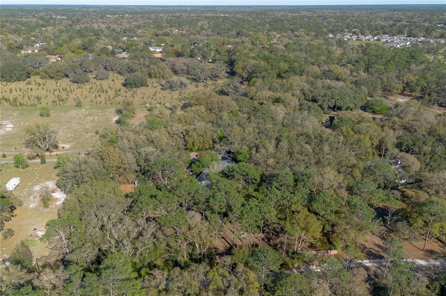 drone / aerial view featuring a forest view