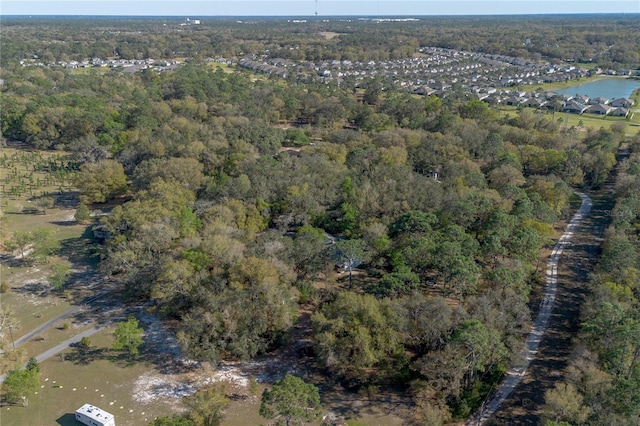 bird's eye view with a view of trees and a water view