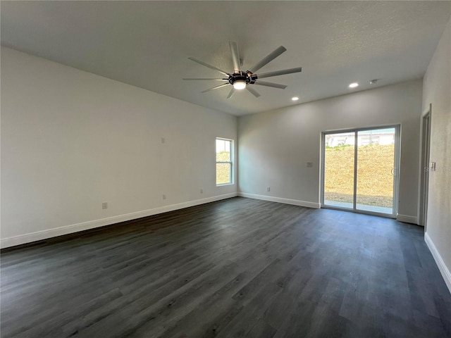 unfurnished room with a ceiling fan, dark wood-style floors, baseboards, recessed lighting, and a textured ceiling