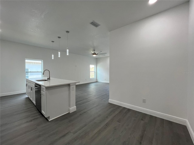 kitchen with visible vents, dark wood finished floors, a sink, white cabinets, and dishwasher