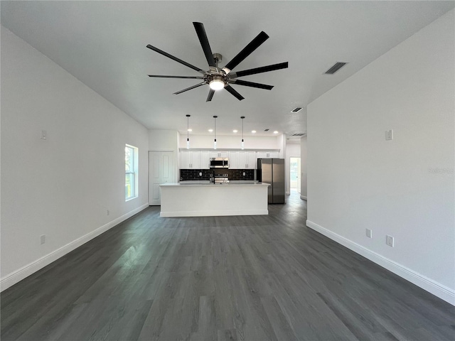 unfurnished living room featuring visible vents, baseboards, recessed lighting, a ceiling fan, and dark wood-style flooring