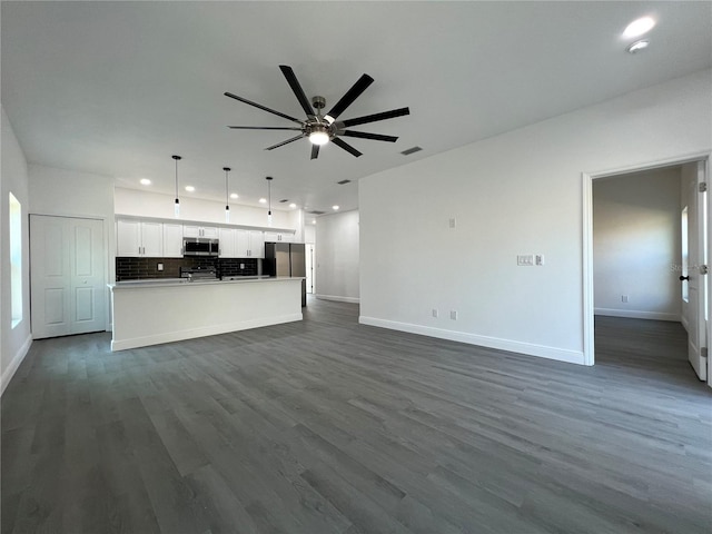 unfurnished living room with recessed lighting, dark wood-style floors, baseboards, and ceiling fan