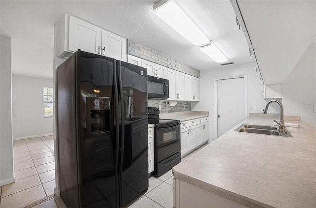 1986 Big Oak Dr, South Daytona, FL 32119 - kitchen featuring visible vents, black appliances, a sink, backsplash, and white cabinetry