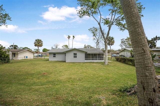1986 Big Oak Dr, South Daytona, FL 32119 - back of house featuring a yard, a fenced backyard, and a sunroom