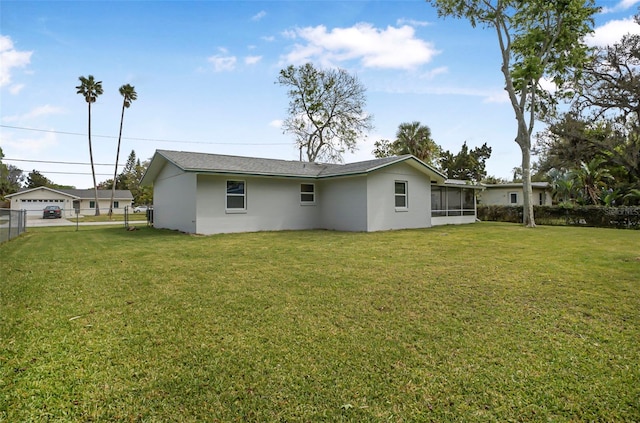 1986 Big Oak Dr, South Daytona, FL 32119 - rear view of house featuring a yard, fence, stucco siding, and a sunroom