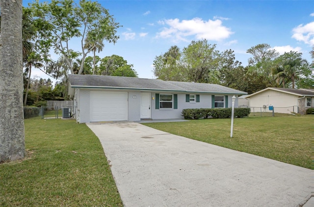1986 Big Oak Dr, South Daytona, FL 32119 - ranch-style house featuring a front lawn, fence, cooling unit, driveway, and an attached garage