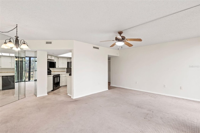 unfurnished living room with ceiling fan with notable chandelier, light colored carpet, visible vents, and baseboards