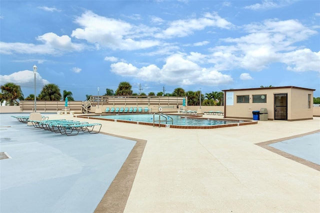 community pool featuring a patio and fence