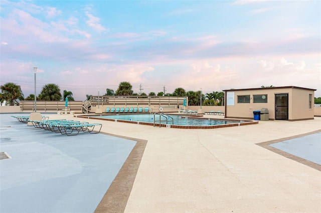 community pool featuring a patio and fence