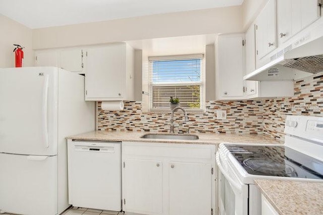 kitchen with tasteful backsplash, white appliances, light countertops, and a sink