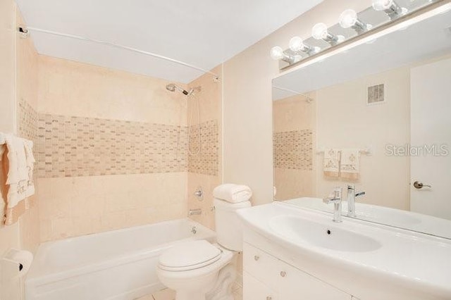 bathroom featuring visible vents, vanity, toilet, and shower / tub combination