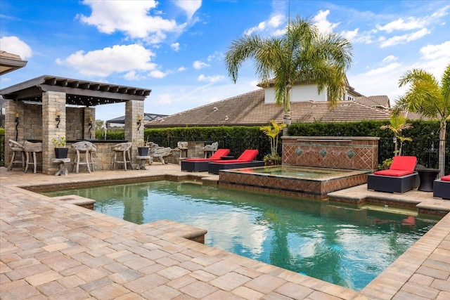 view of pool featuring outdoor dry bar, a fenced in pool, fence, a patio area, and an in ground hot tub