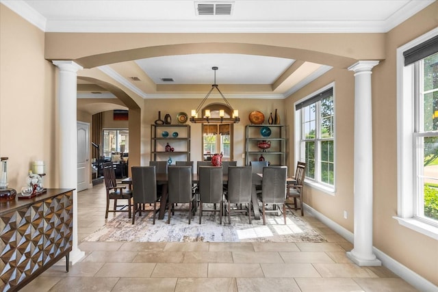 dining space with a wealth of natural light, visible vents, arched walkways, and decorative columns