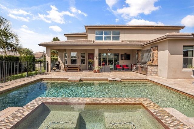 rear view of property with a patio area, area for grilling, stucco siding, and fence