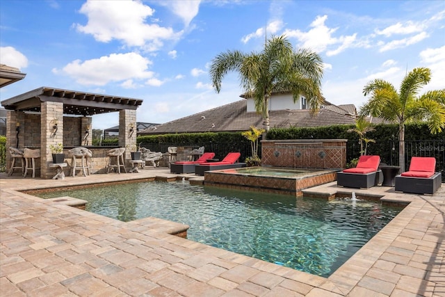 view of swimming pool featuring outdoor dry bar, a patio area, a pool with connected hot tub, and fence