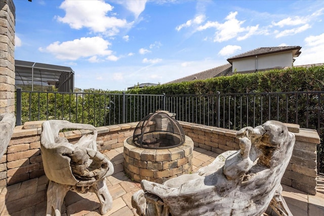 view of patio with fence and a fire pit