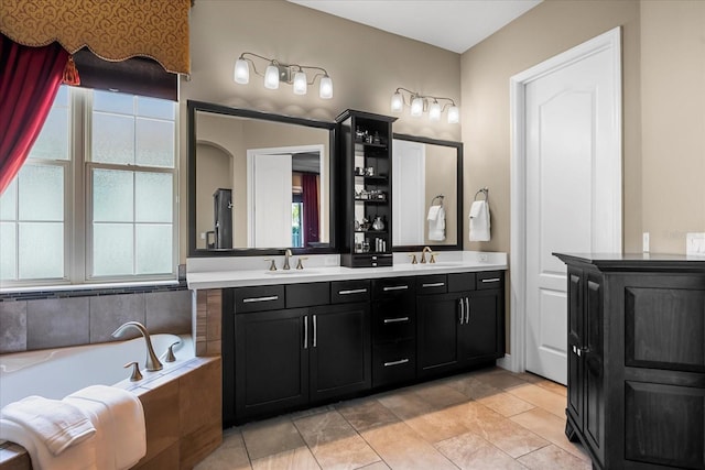 bathroom featuring double vanity, a bath, and a sink