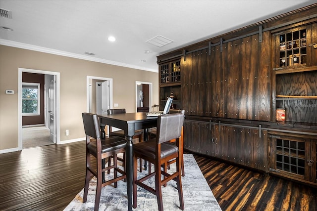 dining area featuring wood finished floors, visible vents, baseboards, recessed lighting, and ornamental molding