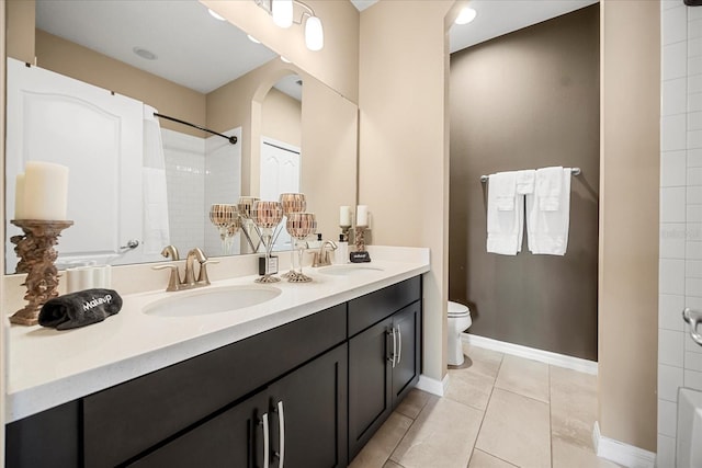 full bath featuring tile patterned flooring, toilet, a shower, and a sink