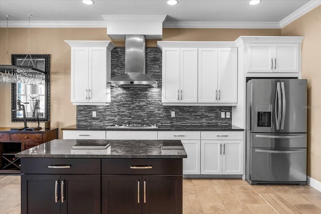 kitchen with white cabinetry, backsplash, wall chimney exhaust hood, and appliances with stainless steel finishes