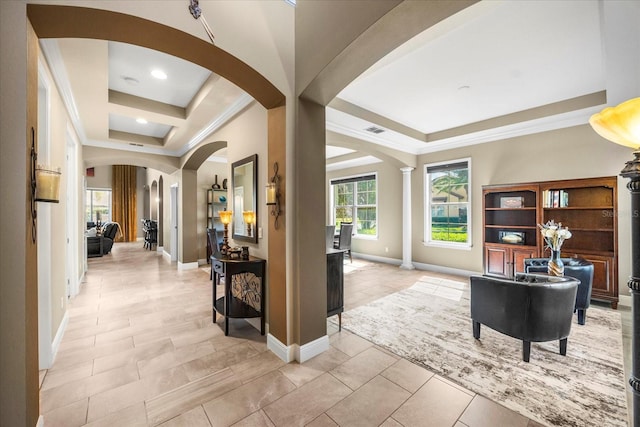 interior space with visible vents, arched walkways, a raised ceiling, and crown molding