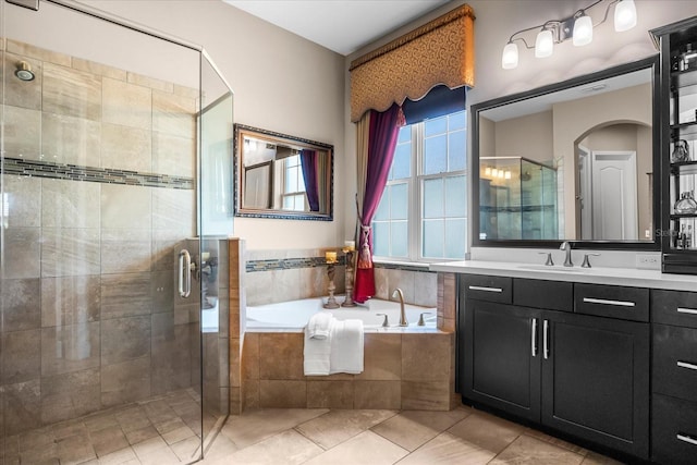 bathroom featuring tile patterned flooring, visible vents, a garden tub, a stall shower, and vanity