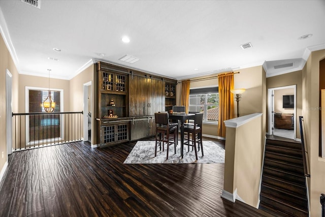 dining room featuring a chandelier, visible vents, baseboards, and wood finished floors