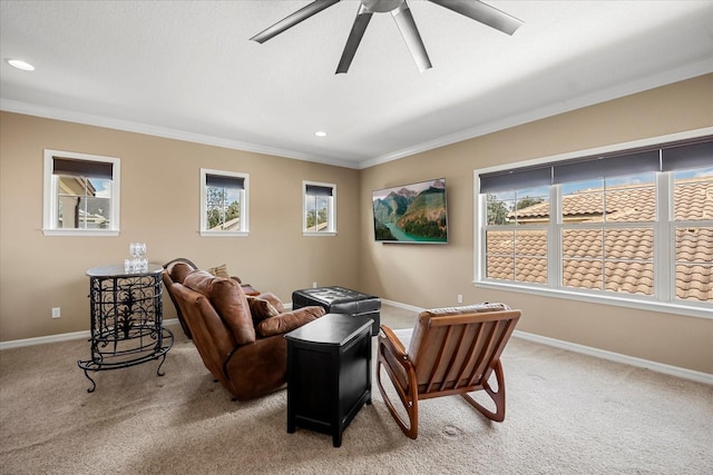 living area with baseboards, light colored carpet, ornamental molding, recessed lighting, and a ceiling fan