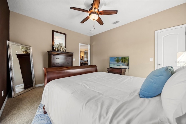 bedroom featuring a ceiling fan, visible vents, carpet floors, and baseboards