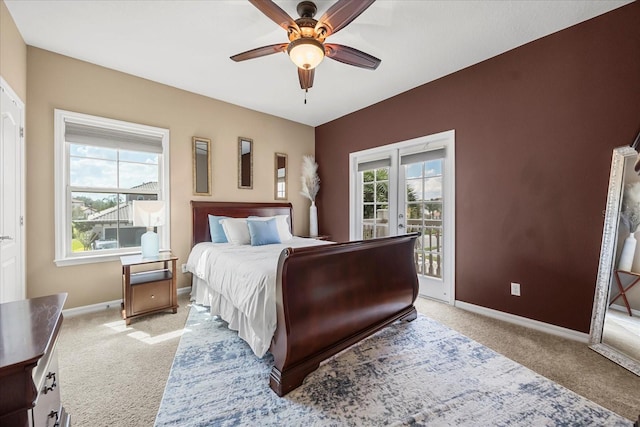 bedroom featuring access to exterior, light colored carpet, baseboards, and ceiling fan