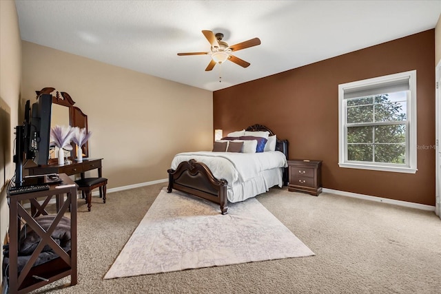 carpeted bedroom with a ceiling fan and baseboards