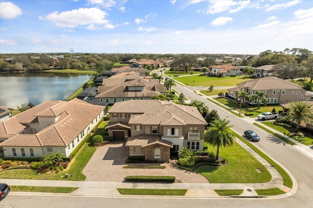 drone / aerial view with a residential view and a water view