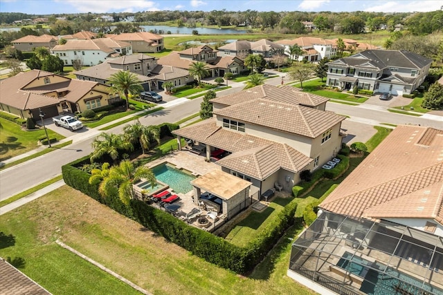 drone / aerial view featuring a residential view and a water view