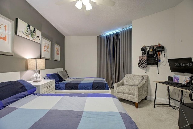 carpeted bedroom featuring baseboards, a textured ceiling, and ceiling fan