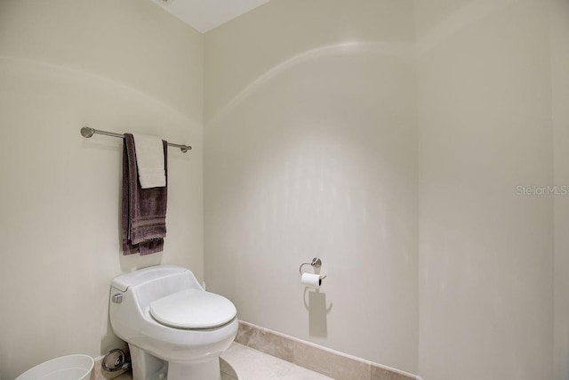 bathroom with tile patterned flooring and toilet