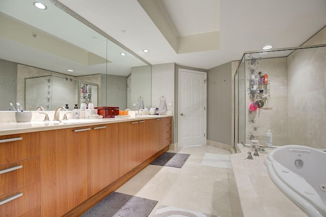 bathroom featuring a tub with jets, double vanity, recessed lighting, a stall shower, and a sink