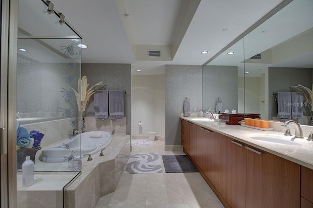 full bath featuring visible vents, a sink, a jetted tub, recessed lighting, and double vanity