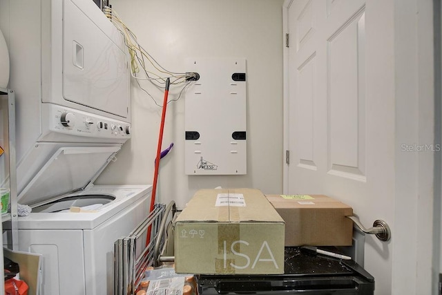 washroom with laundry area and stacked washer / drying machine