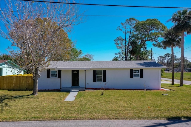 ranch-style house with stucco siding, a front yard, and fence