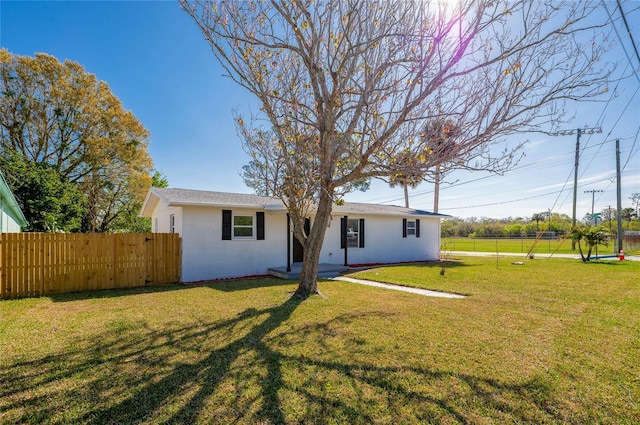 exterior space featuring a front lawn and fence