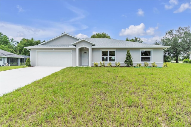 ranch-style house featuring a garage, a front yard, driveway, and stucco siding