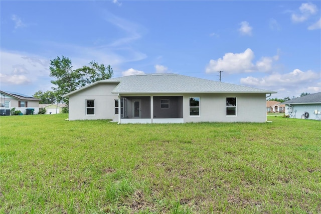 1329 N Old Mill Dr, Deltona, FL 32725 - back of house with stucco siding, a yard, and a sunroom
